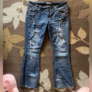 Distressed low rise flared jeans.
